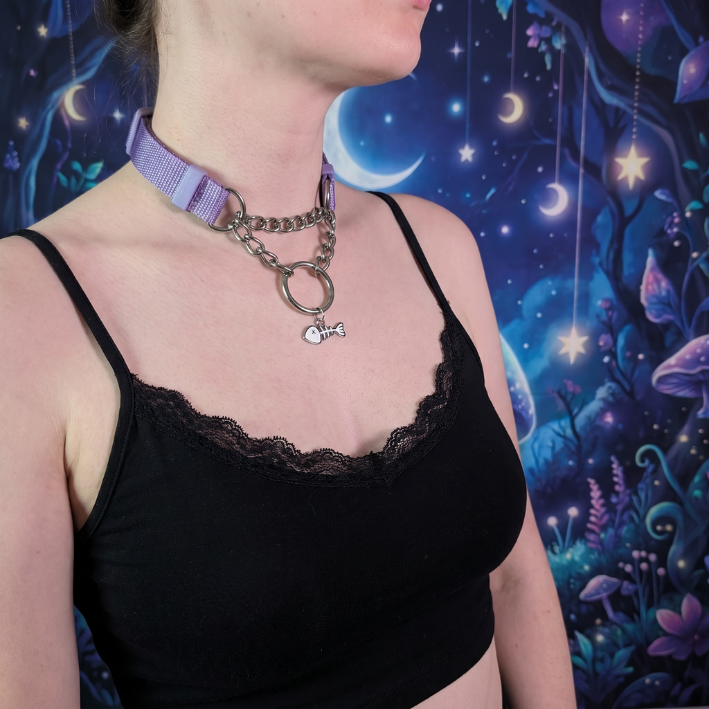 Person wearing a black tank top with a colorful, fantasy-themed background